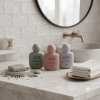 three-pastel-50ml-flat-pe-hand-cream-bottles-beside-bathroom-sink.png