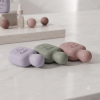 three-pastel-50ml-flat-pe-hand-cream-bottles-lying-on-marble-counter.png