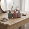 three-pastel-50ml-flat-pe-hand-cream-bottles-on-rustic-bathroom-counter.png