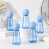 five-blue-50ml-pet-spray-bottles-with-spherical-caps-in-bathroom.png