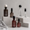 amber-and-clear-pet-essential-oil-spray-bottle-collection-on-gray-display.jpg