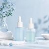 two-frosted-50ml-all-pp-dropper-bottles-in-a-skincare-product-display.jpg