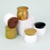gold-white-and-black-pp-cosmetic-cream-jars-on-display-blocks.jpg