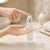 frosted-lotion-pump-dispensing-skincare-onto-hand.jpg