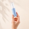 hand-holding-blue-pp-airless-skincare-bottle.jpg