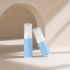 two-blue-pp-airless-travel-bottles-on-ivory-background.jpg