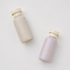 beige-and-pink-wheat-straw-travel-bottles-flat-lay.jpg