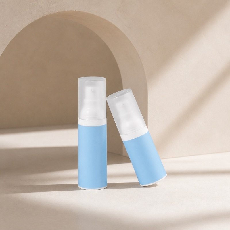two-blue-pp-airless-travel-bottles-on-ivory-background.jpg
