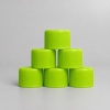 green-flat-top-plastic-caps-in-group.jpg