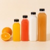 clear-pet-square-juice-bottles-displayed-with-fresh-orange-fruit.jpg
