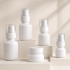 white-pet-cosmetic-bottle-and-jar-collection-on-tiered-blocks.jpg