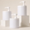 three-white-wide-mouth-pet-lotion-pump-jars-on-display-blocks.jpg