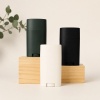 dark-green-white-and-black-deodorant-stick-containers-on-risers.jpg