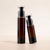 15ml-30ml-50ml-100ml-amber-pet-cosmetic-pump-bottle-two-bottle-display-with-clear-protective-caps.jpg