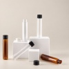 89mm-to-120mm-pet-pcr-child-resistant-packaging-tube-shown-disassembled-with-screw-caps-on-display-blocks.jpg