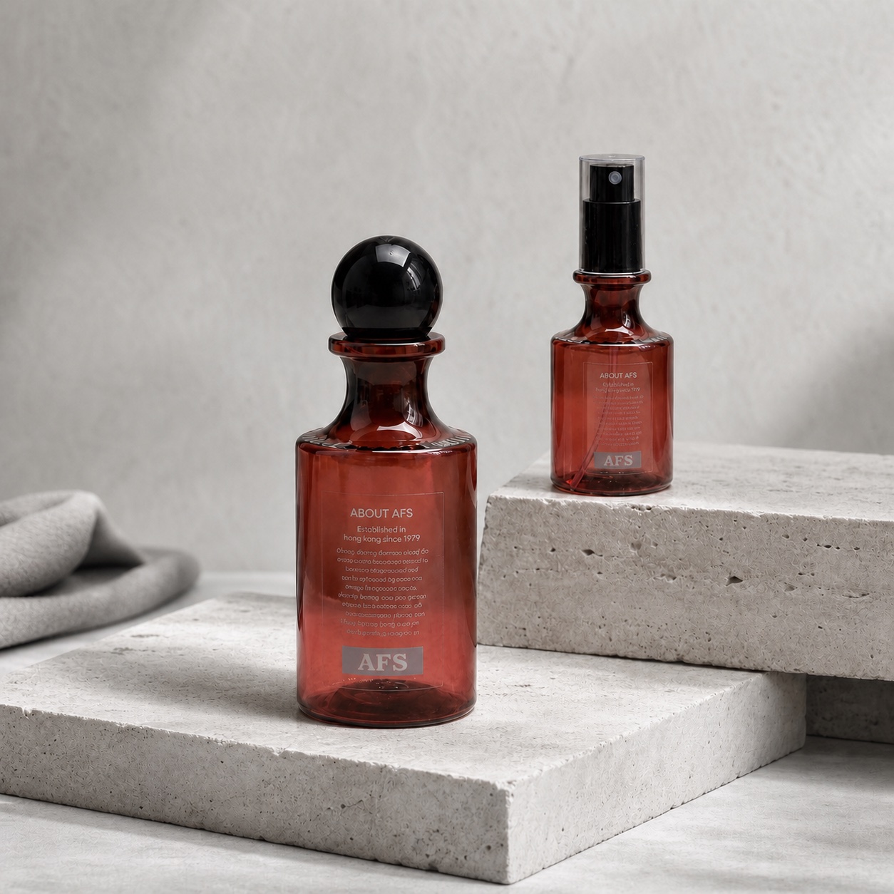amber-pet-essential-oil-and-fine-mist-spray-bottles-on-stone-podium