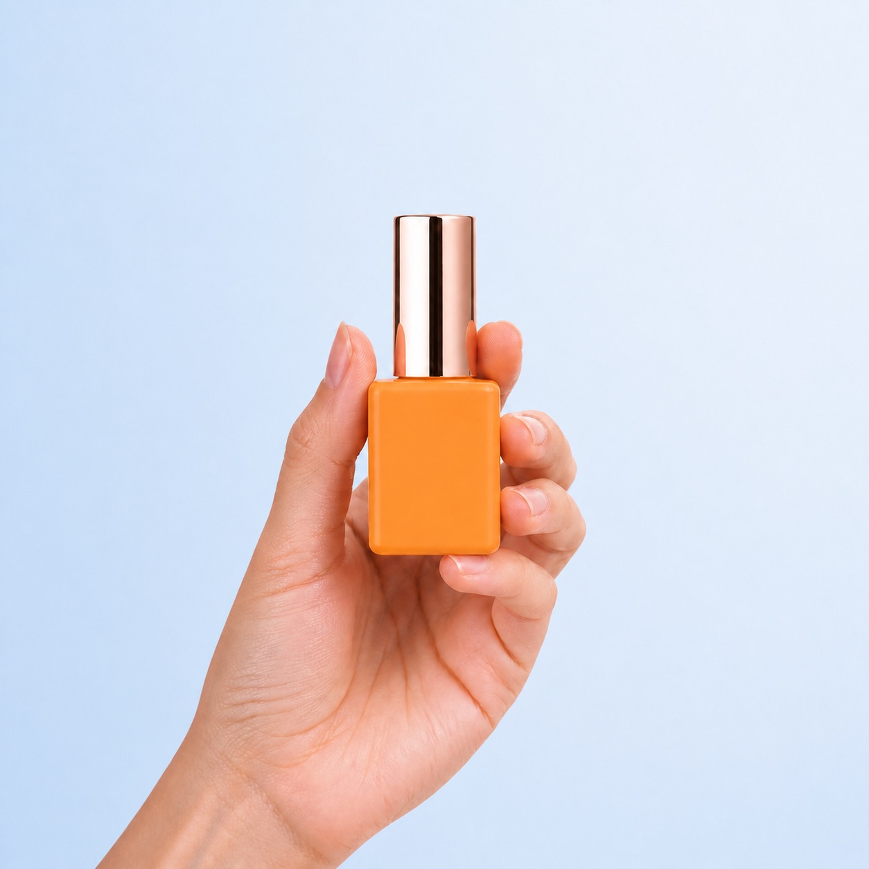hand-holding-orange-pe-nail-polish-bottle