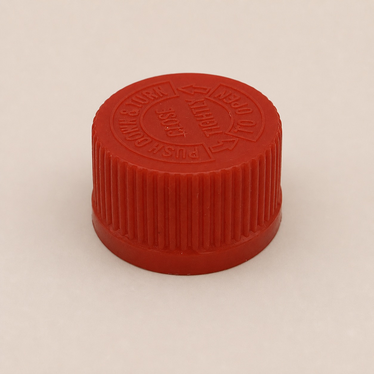 red-embossed-press-and-turn-safety-cap-close-up