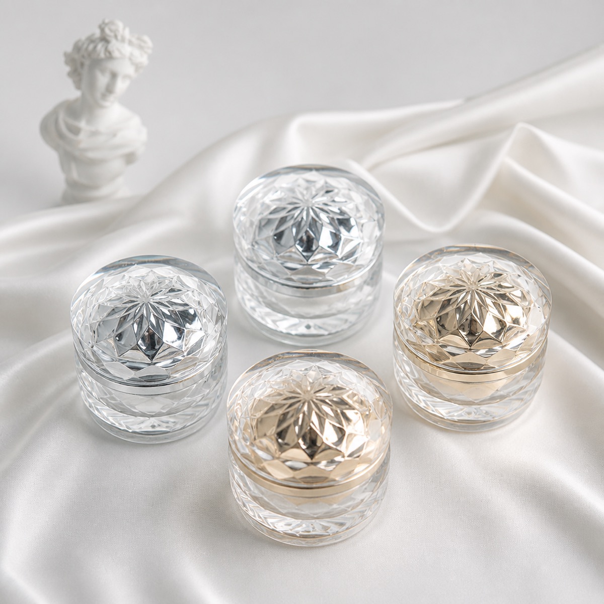 four-gold-and-silver-acrylic-crystal-cosmetic-jars-on-satin