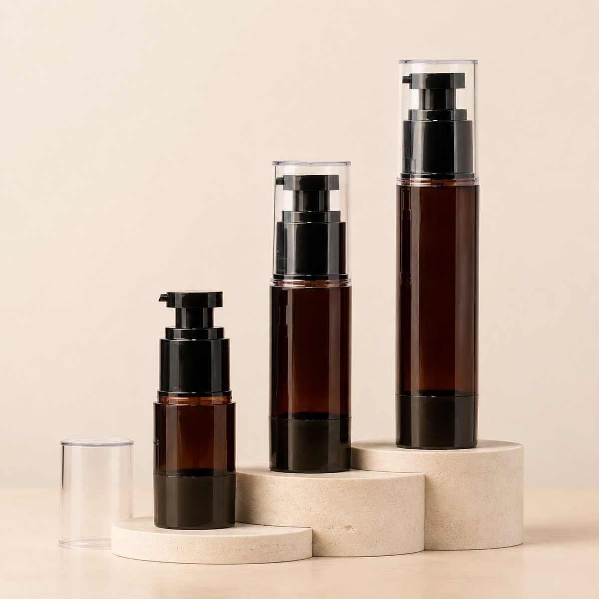 15ml-30ml-50ml-100ml-amber-pet-cosmetic-pump-bottle-four-capacity-bottle-lineup-on-a-neutral-display