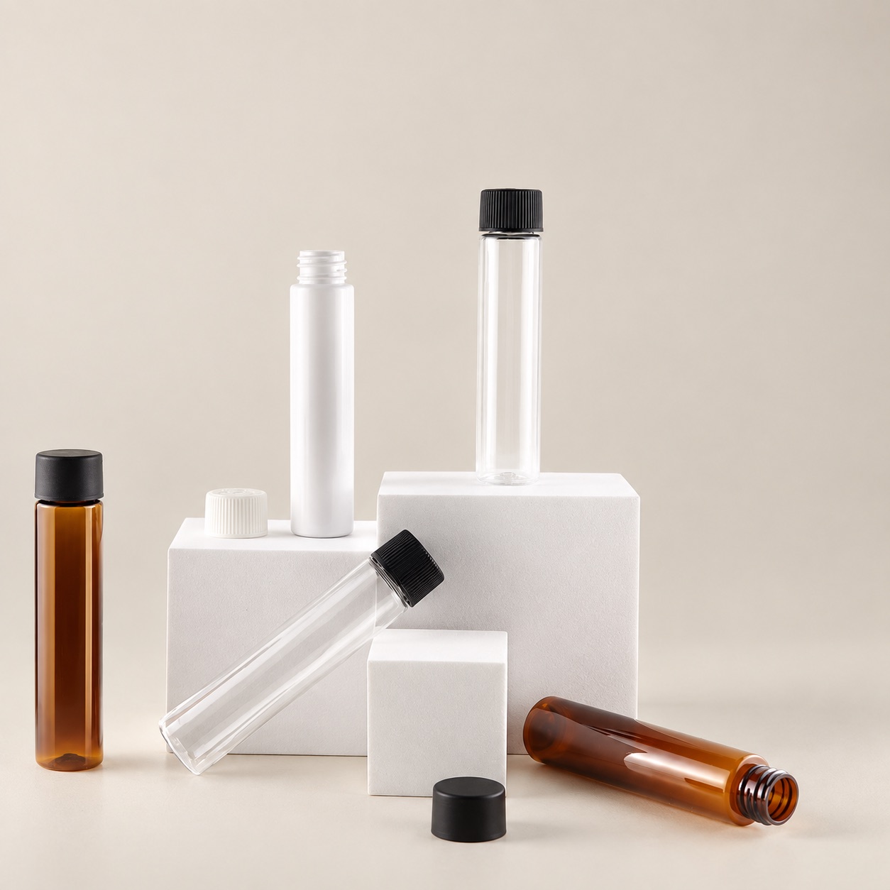 89mm-to-120mm-pet-pcr-child-resistant-packaging-tube-shown-disassembled-with-screw-caps-on-display-blocks